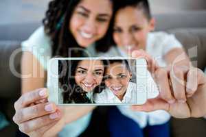 Portrait of lesbian couple taking a selfie on phone