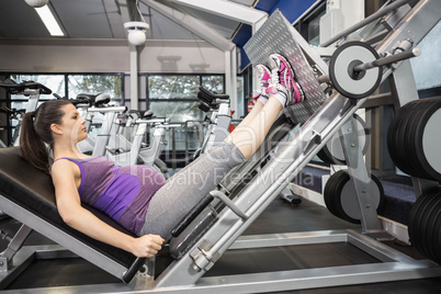 Pregnant woman using weight machine