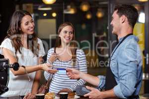 Smiling clients paying with card