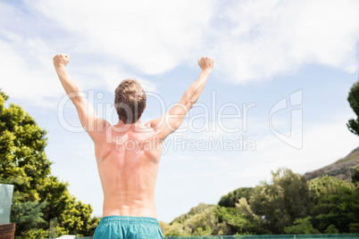 Young man standing near poolside