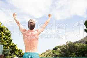 Young man standing near poolside