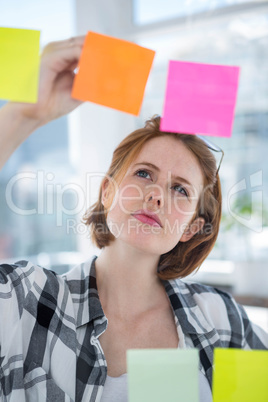 thoughtful hipster woman brainstorming over notes