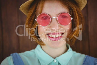 Cute red haired hipster smiling to the camera