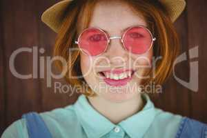 Cute red haired hipster smiling to the camera