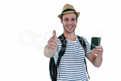 Smiling handsome man holding a leather wallet and showing thumbs