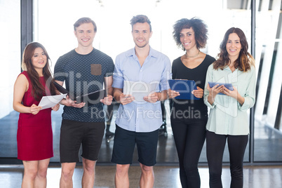 Colleagues standing with document and digital tablet