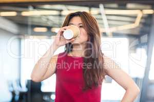 Beautiful young woman having coffee