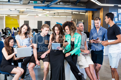 Group of colleagues talking in office