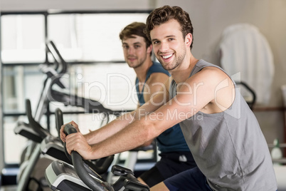 Fit people doing exercise bike