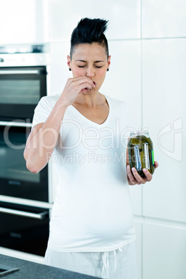 Pregnant woman eating pickles