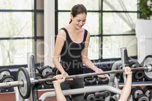 Trainer woman helping athletic man