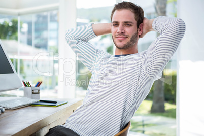 Handsome businessman relaxing on his desk chair