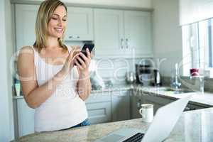 Pretty blonde woman looking at smartphone