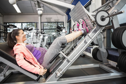 Pregnant woman using weight machine