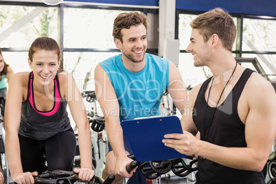 Fit group of people using exercise bike together