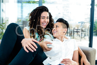 Lesbian couple watching television