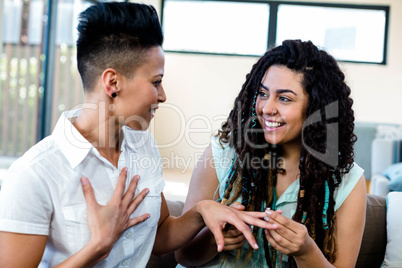 Woman putting a ring on her partners finger