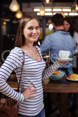 Smiling woman holding white cup Smiling woman holding white cup