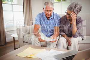 Senior man showing documents to woman