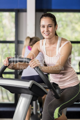 Fit woman doing exercise bike