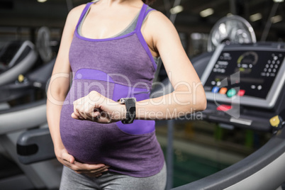 Pregnant woman using smart device