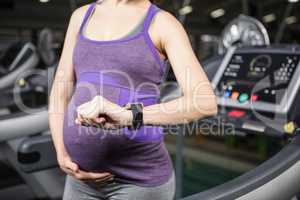 Pregnant woman using smart device