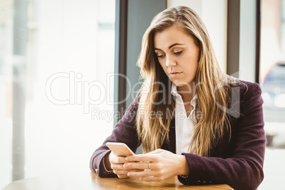 Cute blonde girl texting