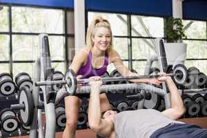 Trainer woman helping athletic man