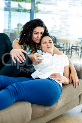 Lesbian couple watching television