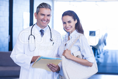 Doctor and colleague looking at camera