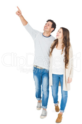 Smiling couple pointing away