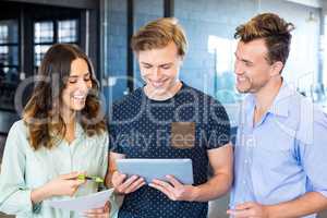 Three confident colleagues discussing in office