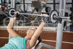 Woman using weight machines