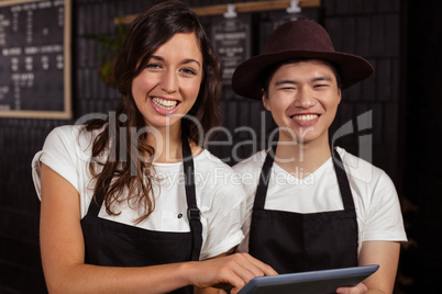 Smiling co-workers using tablet