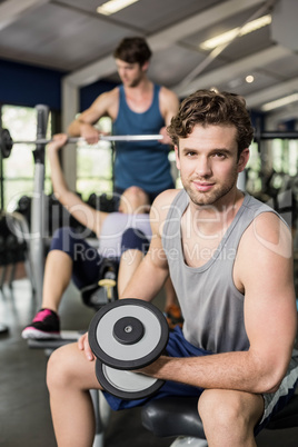 Fit man lifting dumbbell