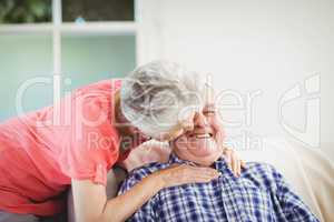 Senior woman kissing man on cheek