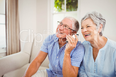 Senior couple talking on mobile phone