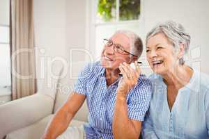 Senior couple talking on mobile phone