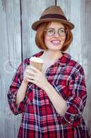 smiling hipster woman holding a coffee cup