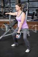 Pregnant woman lifting kettlebell