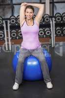 Determined woman exercising on fitness ball