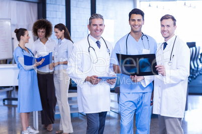 Doctors holding an x-ray and smiling