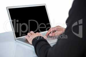 Handsome man in black hoodie using laptop