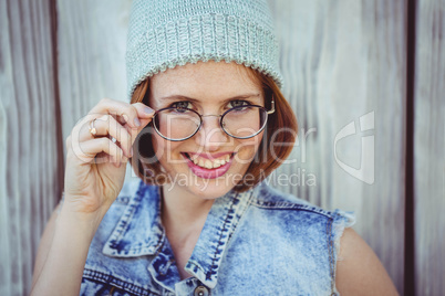 smiling hipster woman in glasses and a beanie hat