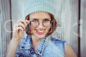 smiling hipster woman in glasses and a beanie hat