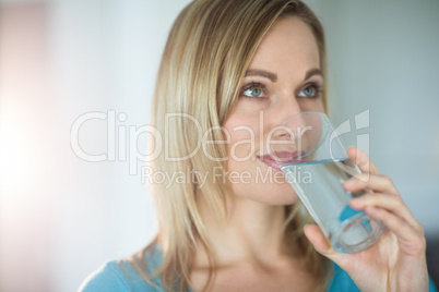 Pretty blonde woman drinking a glass of water