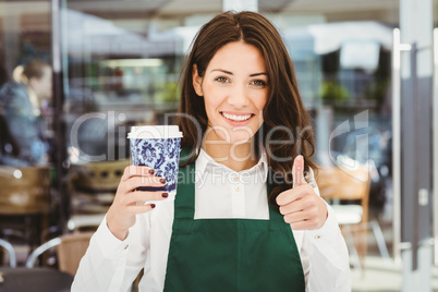 Smiling waitress serving a coffee