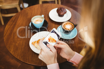 Woman taking picture of food