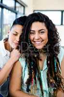 Smiling lesbian couple relaxing on sofa