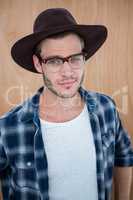 Handsome hipster wearing nerd glasses and hat